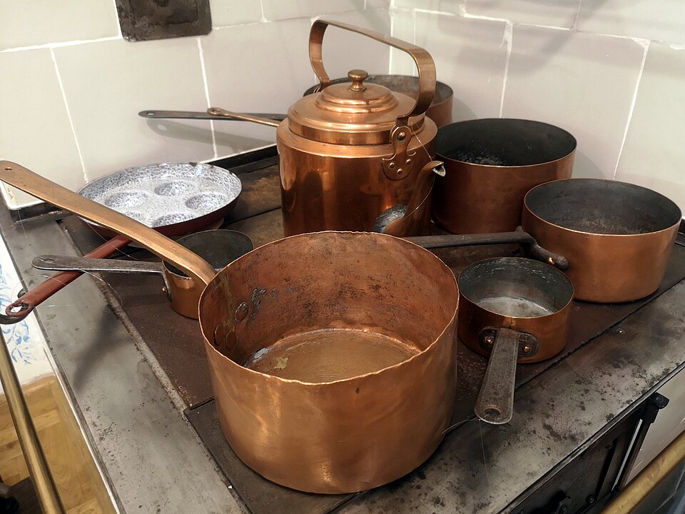 Copper pans and a kettle on an old kitchen range
