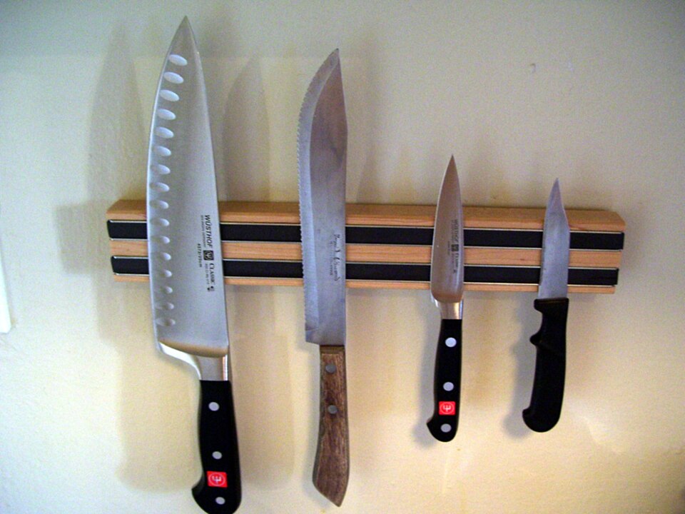 Kitchen knives held on a wall-mounted magnetic strip