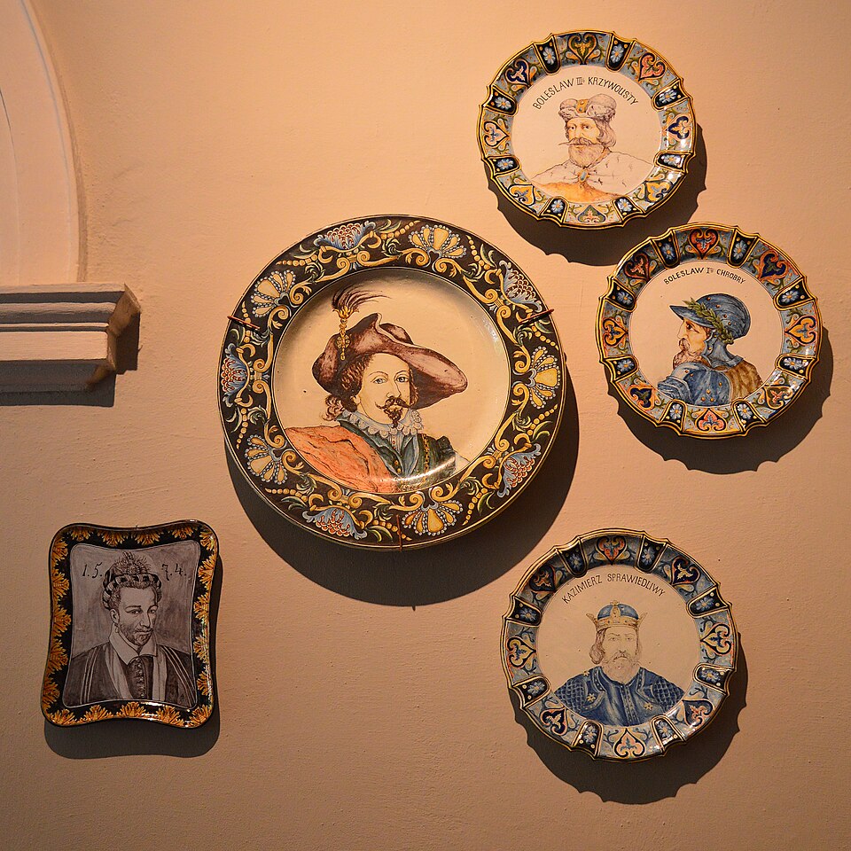 Decorative painted plates hung in a group on a wall