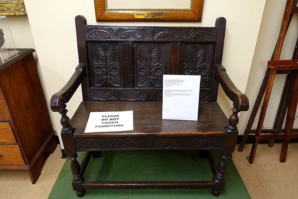 A carved oak settle from before 1700