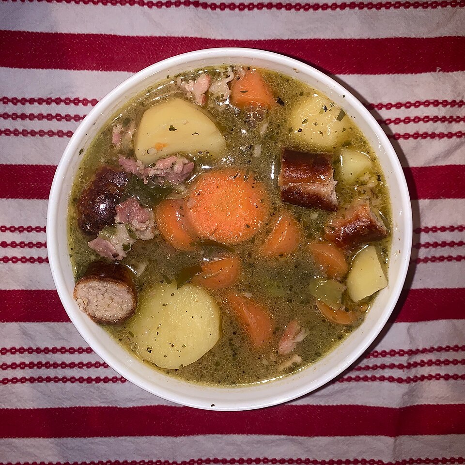 A bowl of Dublin coddle with sausages, potatoes and carrots