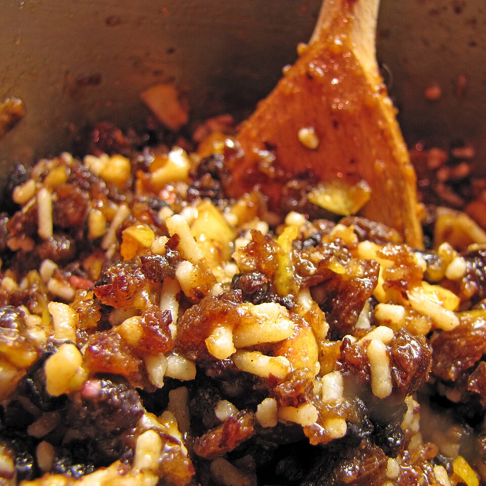 Homemade mincemeat being stirred with a wooden spoon