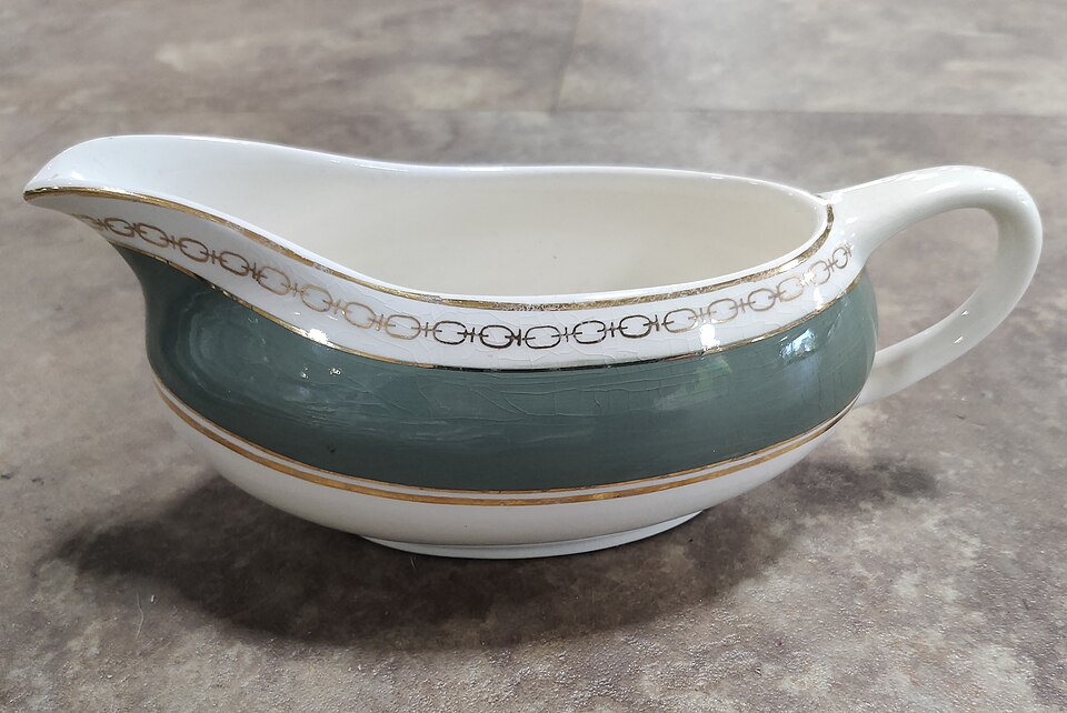 A china gravy boat with a green band