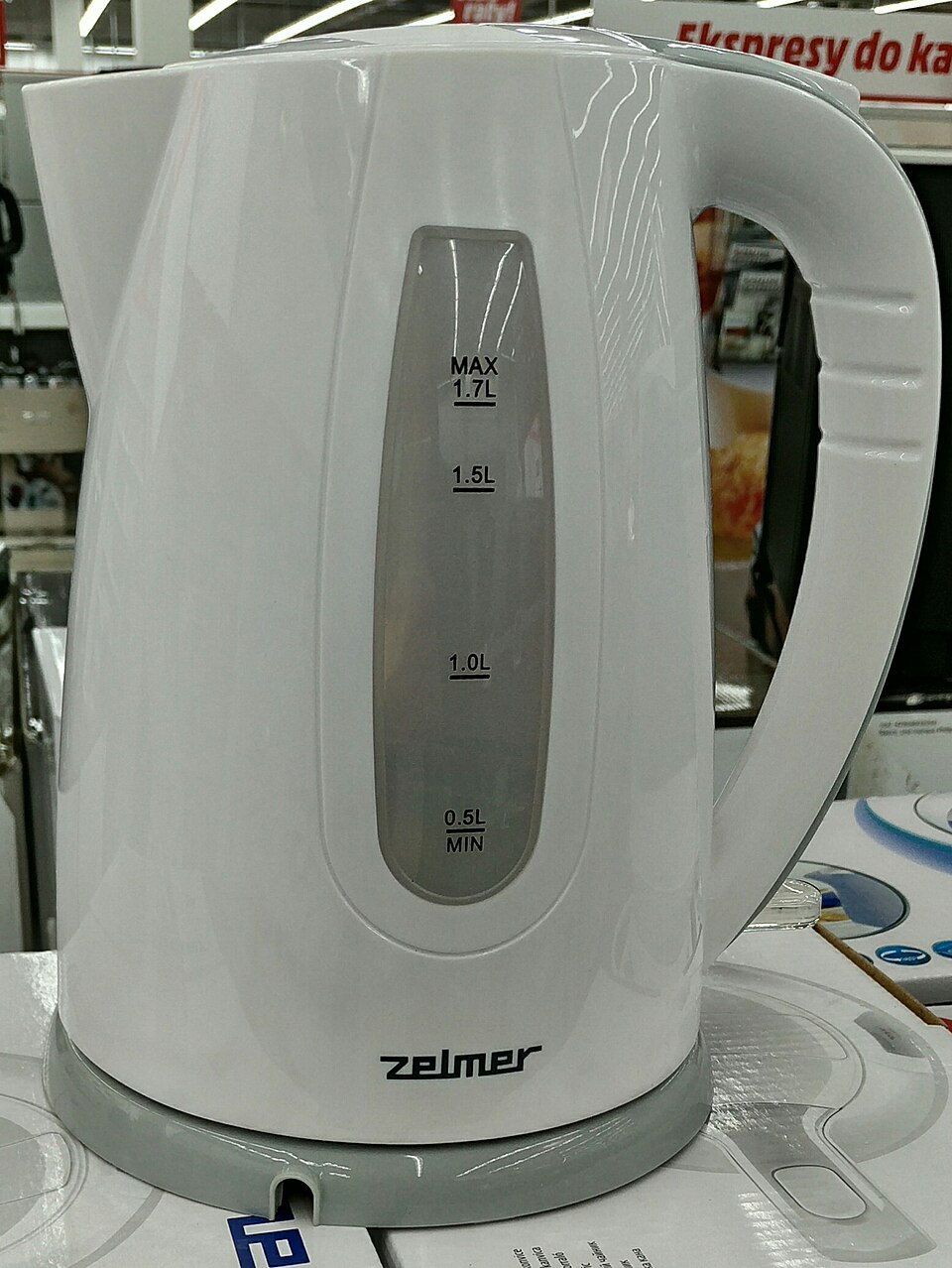 A white electric kettle with a water gauge
