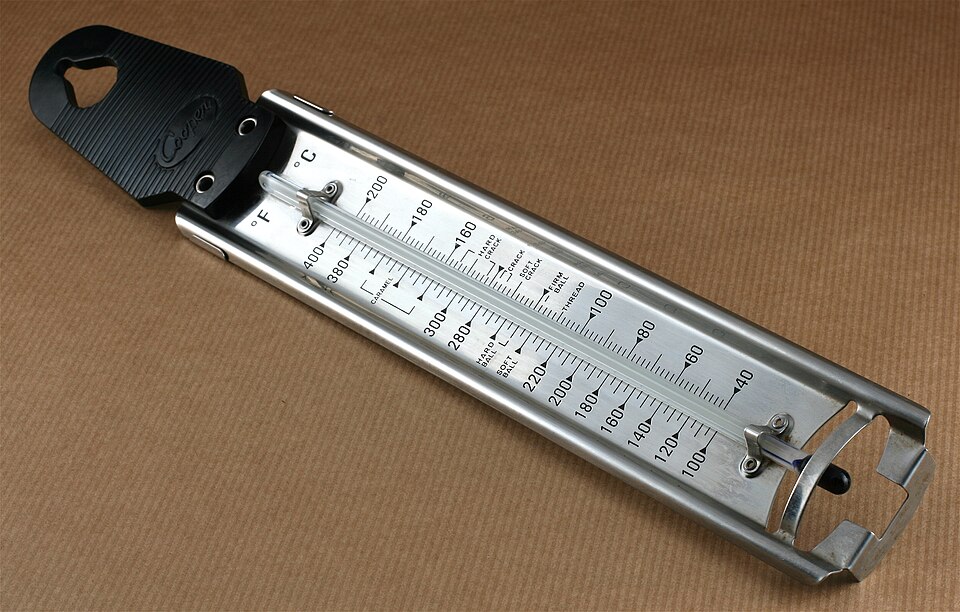 A stainless steel sugar thermometer with a pan clip