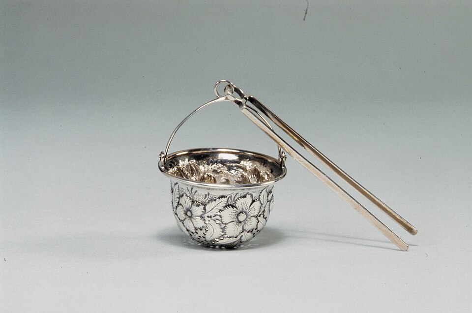 A silver tea strainer