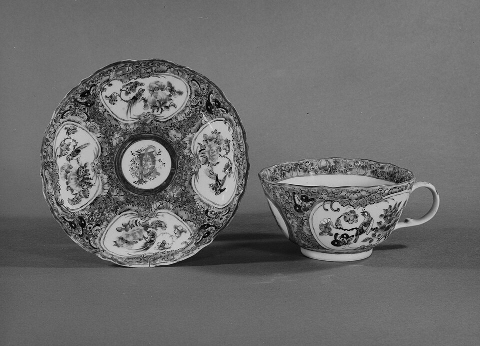 A decorated porcelain teacup and saucer